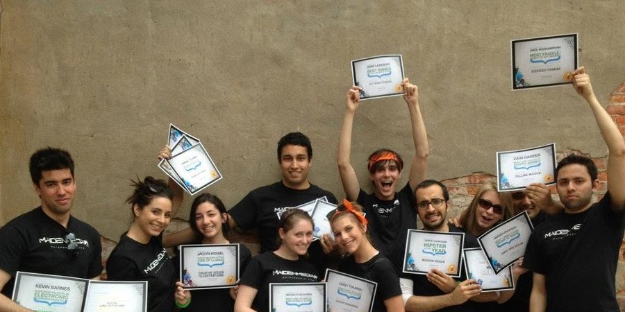 The Maiden Media team outside the Philadelphia office, holding up internal awards certificates.